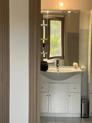 a bathroom with a white sink and a window at Nissa la bella, Piscine et vue mer in Nice