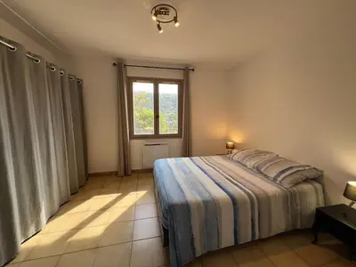 a bedroom with a bed and a window at Nissa la bella, Piscine et vue mer in Nice