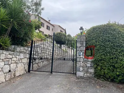 a gate to a house with a stone wall at Nissa la bella, Piscine et vue mer in Nice