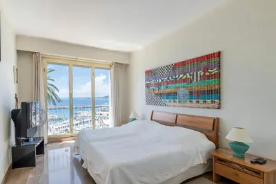 a bedroom with a bed and a large window at Nice Absea le Port 1 in Nice