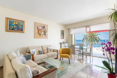 a living room with a couch and a glass table at Nice Absea le Port 1 in Nice