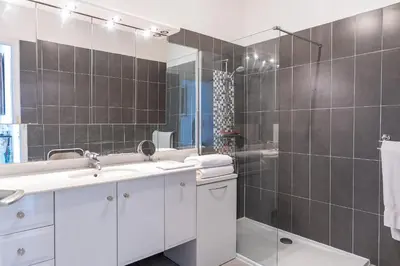 a bathroom with a shower and a sink and a mirror at Nice Absea le Port 1 in Nice