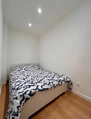 a small bed in a corner of a room at Collet Résidence in Nice