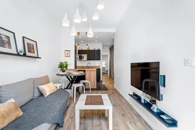 a living room with a couch and a table at Nice Renting - ROSSETTI - Modern Haven Heart of Old Nice in Nice