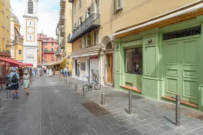 a group of people walking down a street with buildings at Nice Renting - ROSSETTI - Modern Haven Heart of Old Nice in Nice
