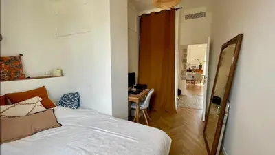 a bedroom with a bed and a desk and a mirror at Bright, Spacious 2 Bedroom Apartment, Walk to Beach & Old Town in Nice