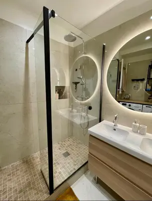 a bathroom with a glass shower and a sink at Bright, Spacious 2 Bedroom Apartment, Walk to Beach & Old Town in Nice