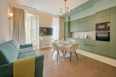 a kitchen and living room with a couch and a table at Aparthotel 9 ALBERTI Nice Centre in Nice