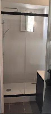 a shower in a bathroom with a glass door at appartement proche centre ville in Nice