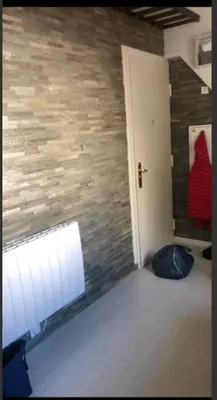 a room with a brick wall and a white door at appartement proche centre ville in Nice