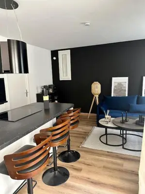 a living room with a blue couch and chairs at Appartement neuf et rénové promenade des anglais in Nice