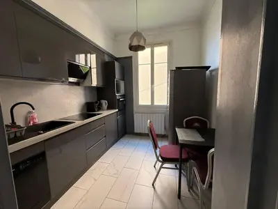 a small kitchen with a table and chairs in it at Charming house near Center Nice with new air conditioner in Nice