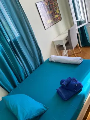 a bed with blue sheets and two towels on it at Wunderschöne Wohnung in Jugendstilvilla am Hafen in Nice