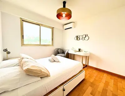 a white bedroom with a bed and a window at Le St Charles in Saint-Laurent-du-Var