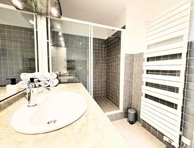 a bathroom with a sink and a shower at Le St Charles in Saint-Laurent-du-Var