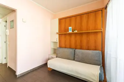 a bench in a room with a wooden wall at Royal Luxembourg AP4397 By Riviera Holiday Homes in Nice