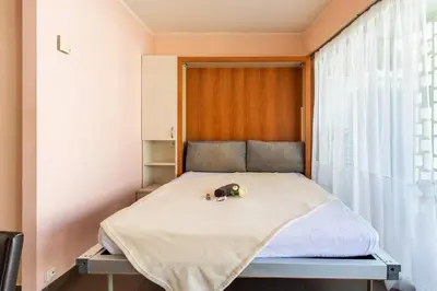 a small bed in a room with a window at Royal Luxembourg AP4397 By Riviera Holiday Homes in Nice