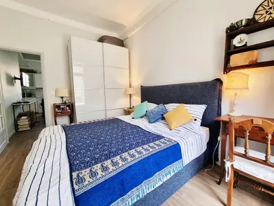 a bedroom with a bed with blue and yellow pillows at 