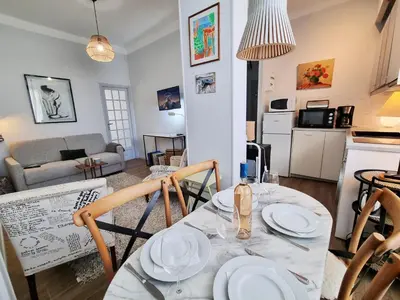 a kitchen and living room with a table and chairs at 