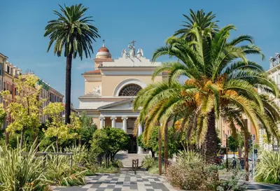 a building with palm trees in front of it at 