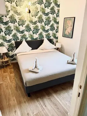 a bedroom with a bed with shoes on it at All new charming 1br hyper centre with balcony and AC in Nice