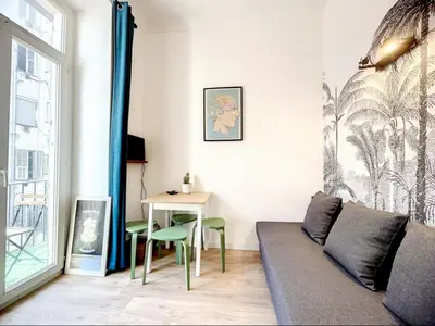 a living room with a couch and a table at All new charming 1br hyper centre with balcony and AC in Nice