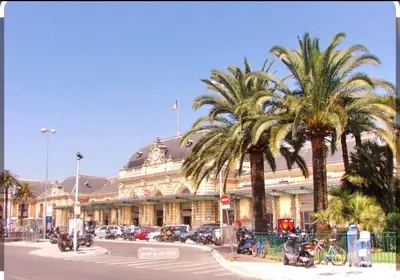 a large building with palm trees in front of it at All new charming 1br hyper centre with balcony and AC in Nice