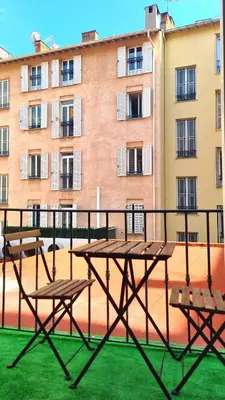 a picnic table and benches on a balcony with a building at All new charming 1br hyper centre with balcony and AC in Nice