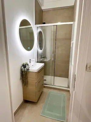 a bathroom with a sink and a shower with a mirror at Magnifique T4 - Spacieux Haut Standing - AC - WIFI - Coeur de Nice in Nice