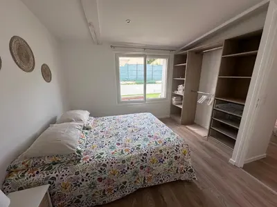 a bedroom with a bed and a window at appartement au calme avec jardin privatif dans maison in Cagnes-sur-Mer