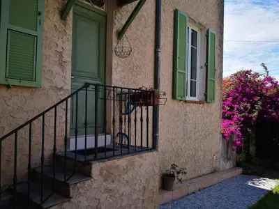 a house with a staircase and a green door at STUDIO dans Villa à Nice Ouest in Nice