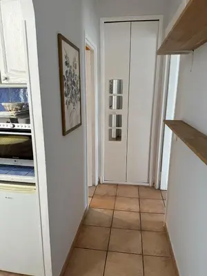 a kitchen with white walls and a tile floor at STUDIO dans Villa à Nice Ouest in Nice