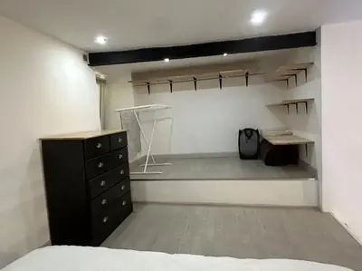 a bedroom with a bed and a dresser and a desk at Charmant studio avec mezzanine in Nice