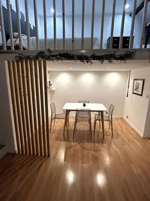 a dining room with a table and two chairs at Charmant studio avec mezzanine in Nice