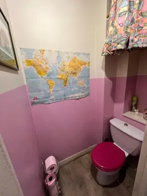 a bathroom with a toilet and a map on the wall at Studio style vintage à Nice in Nice