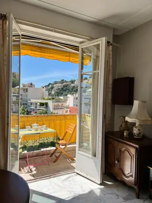an open door to a balcony with a table at Studio style vintage à Nice in Nice