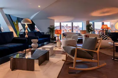 a living room with couches and chairs at Doubletree By Hilton Nice Centre Iconic in Nice