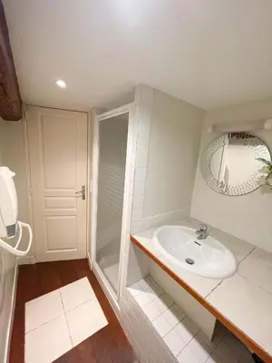 a white bathroom with a shower and a sink at Charmant appartement atypique au coeur du Vieux-Nice in Nice
