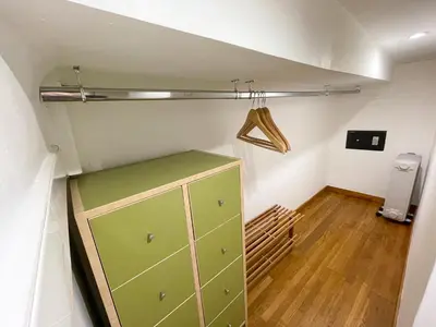 a room with a green cabinet in a attic at Charmant appartement atypique au coeur du Vieux-Nice in Nice