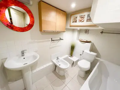 a bathroom with a sink and a toilet and a mirror at Charmant appartement atypique au coeur du Vieux-Nice in Nice