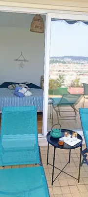 a room with a bed and a table and chairs at Chambre vue Nice & mer in Nice