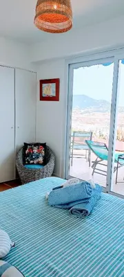 a bedroom with a bed with a view of a patio at Chambre vue Nice & mer in Nice