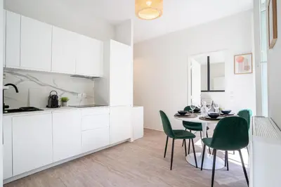 a kitchen and dining room with a table and chairs at 06BZ - Modern apartment in the heart of the port in Nice
