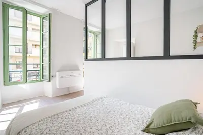 a white bedroom with a bed and two windows at 06BZ - Modern apartment in the heart of the port in Nice