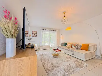 a living room with a couch and a table at Canta Galet - Wifi, AC, Parking, 4pers in Nice