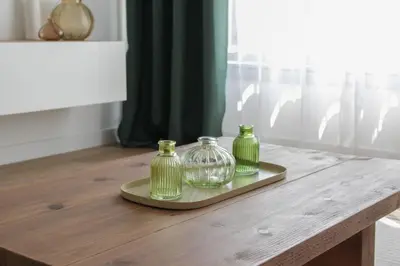 two green glass vases on a tray on a wooden table at Appartement - Proche plage & gare in Cagnes-sur-Mer