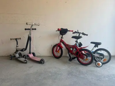 three bikes and scooters are parked next to a wall at Calm#Child friendly#Home#Beach#Airport in Saint-Laurent-du-Var