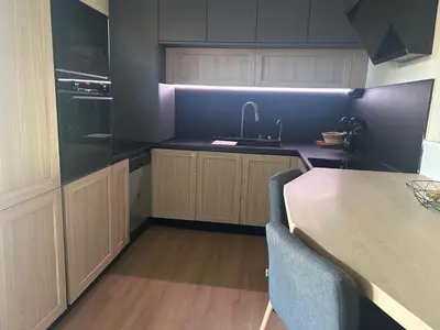 a kitchen with a sink and a table with chairs at Calm#Child friendly#Home#Beach#Airport in Saint-Laurent-du-Var