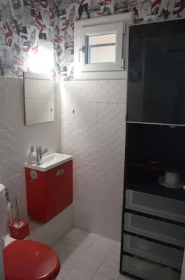 a small bathroom with a red toilet and a sink at Calm#Child friendly#Home#Beach#Airport in Saint-Laurent-du-Var