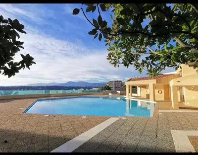 a large swimming pool with a view of the water at Chez Gaël, vue mer, piscine, 3chb in Nice
